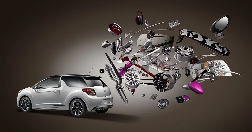 Automotive product shot features a white compact car with separated car parts floating near it against a gradient gray background.