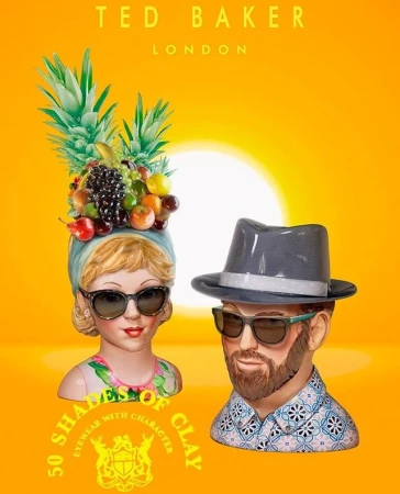 Two mannequin heads wearing sunglasses, one adorned with fruit and a headscarf, the other with a hat, against a bright orange background.