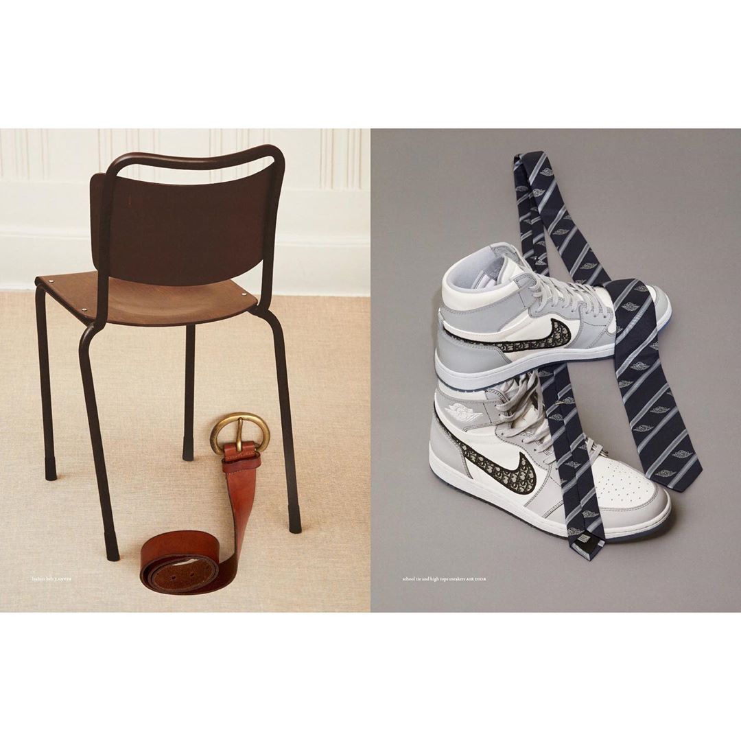 Still life featuring a chair with a leather belt and sneakers stacked with striped neckties on contrasting neutral backgrounds.