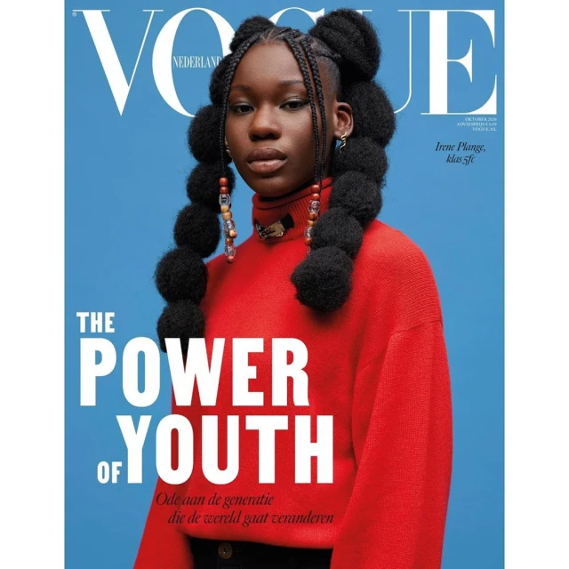 Magazine cover of a young Black woman with beaded braids wearing a red turtleneck sweater against a blue background. Vogue Nederland.
