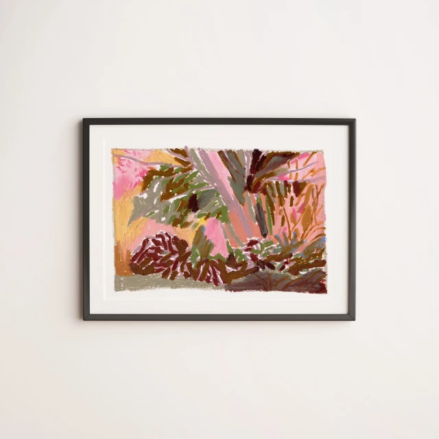 Framed art print on a white wall features an abstract nature landscape with pink, green, and brown brushstrokes, blending realism and impressionism.