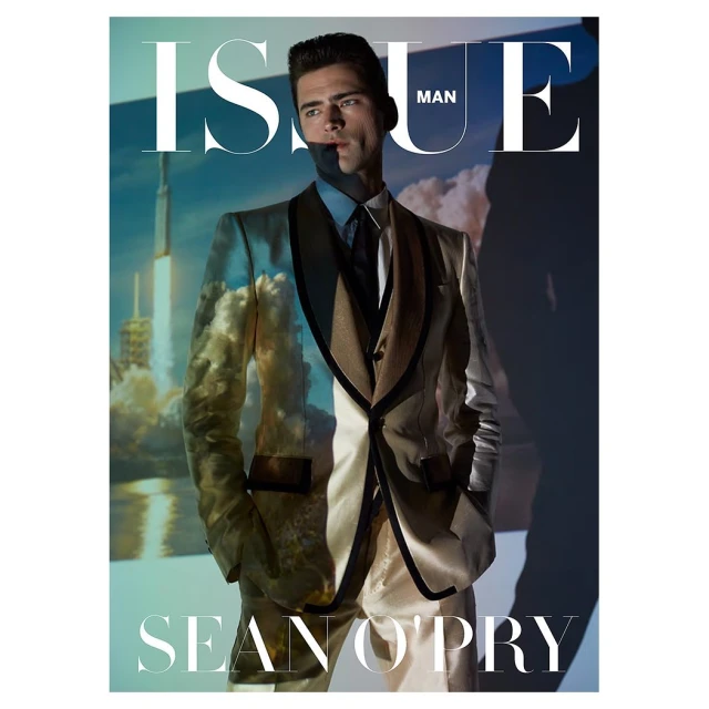 Magazine cover featuring a fair-skinned male model in suit and tie with a rocket launch graphic superimposed in the background and studio lighting.