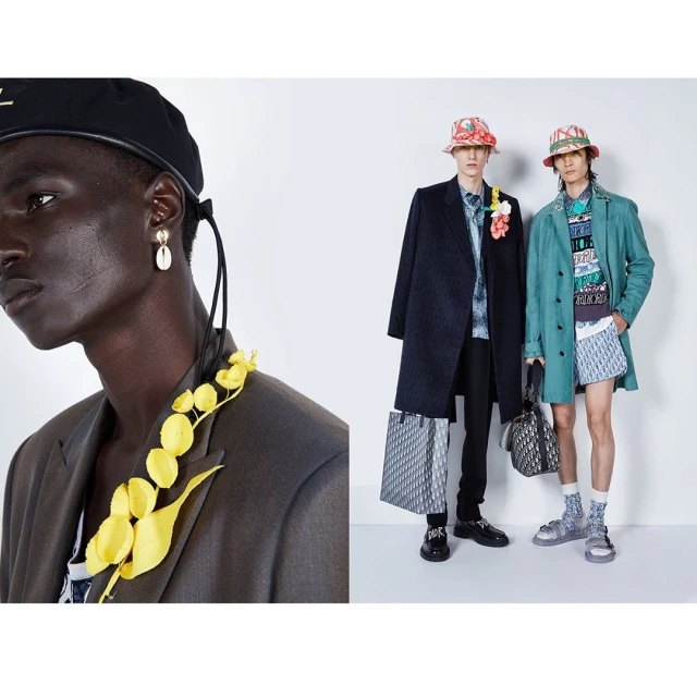 Three male fashion models pose in a photo studio wearing high-fashion clothing, accessories, and statement jewelry against a white backdrop.