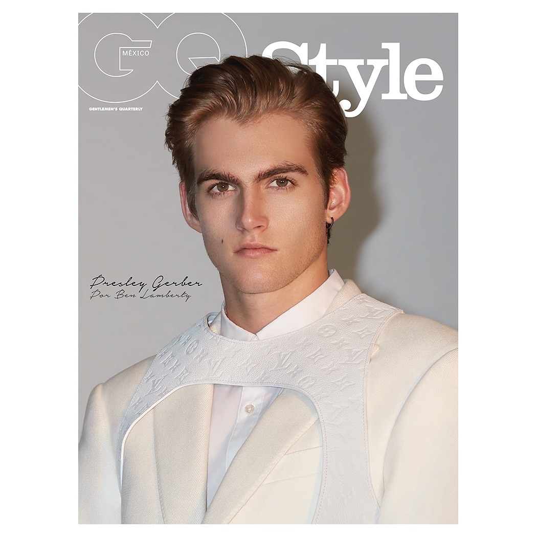 GQ Style cover featuring a fair-skinned adult male model in a white suit. The magazine cover is a portrait in a photo studio.