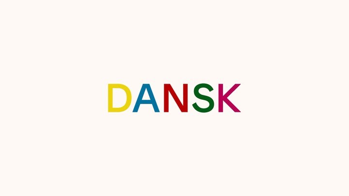 DANSK graphic design with block-letter logo in yellow, blue, red, green, and magenta on cream background in a studio setting.