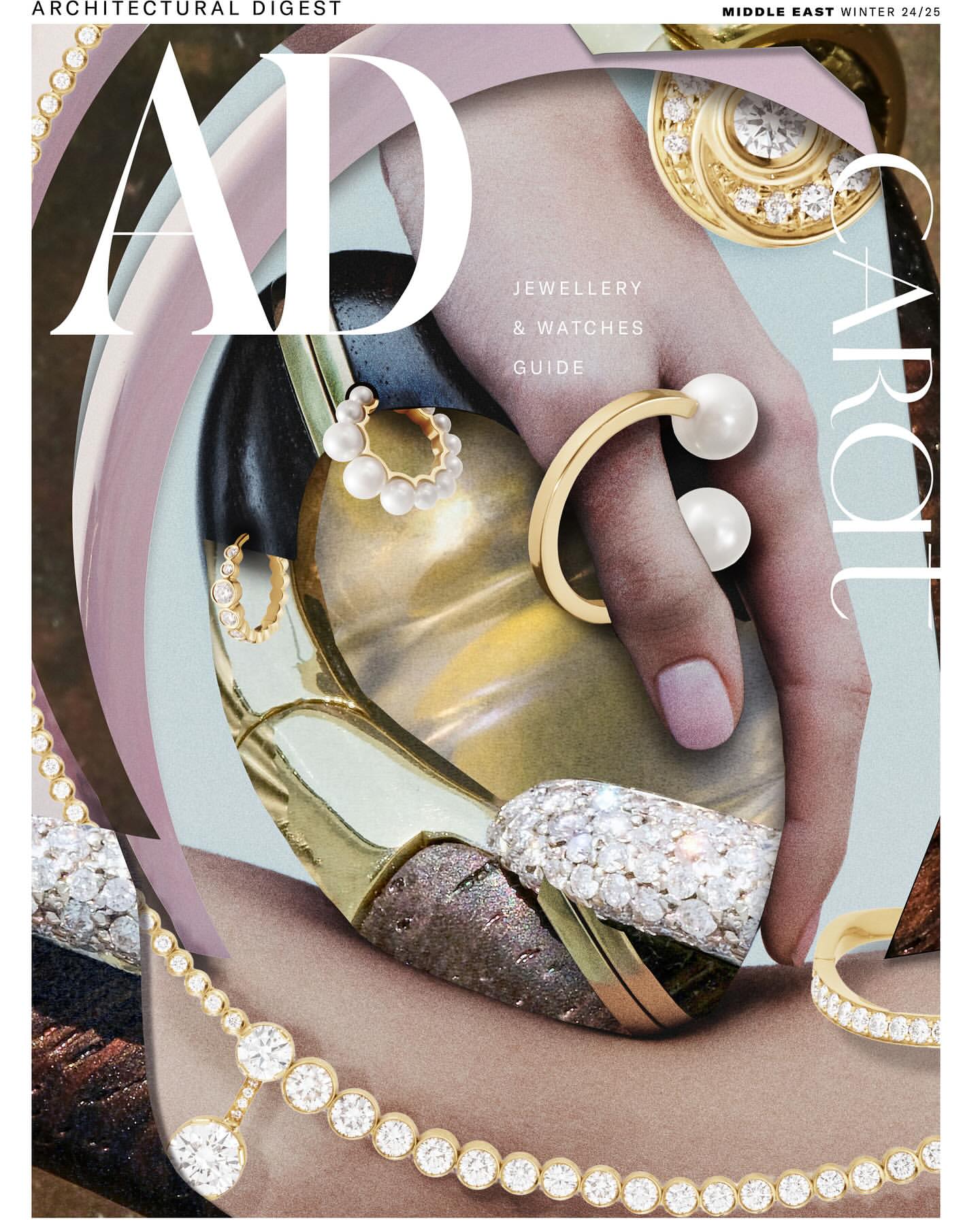 Architectural Digest magazine cover featuring a hand adorned with gold and pearl jewelry, showcasing rings and bracelets, against a stylized backdrop.