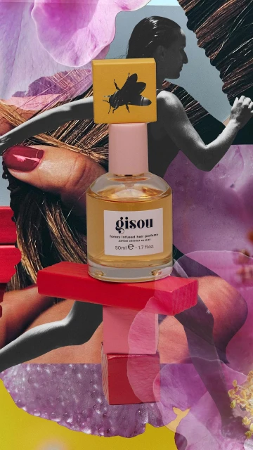 Gisou honey-infused hair perfume bottle with a pink cap and a yellow label, displayed on stacked pink and red blocks in a collage.