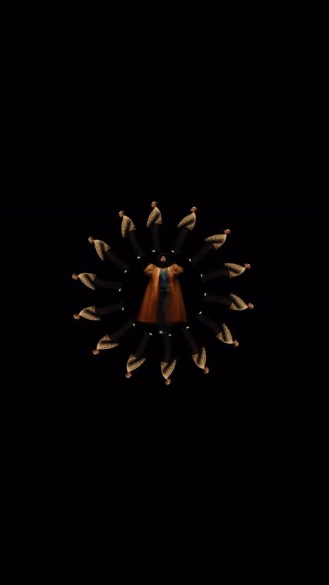 Kaleidoscopic fashion video with people arranged in a circle around a dress in a black background, creating a dynamic visual pattern.