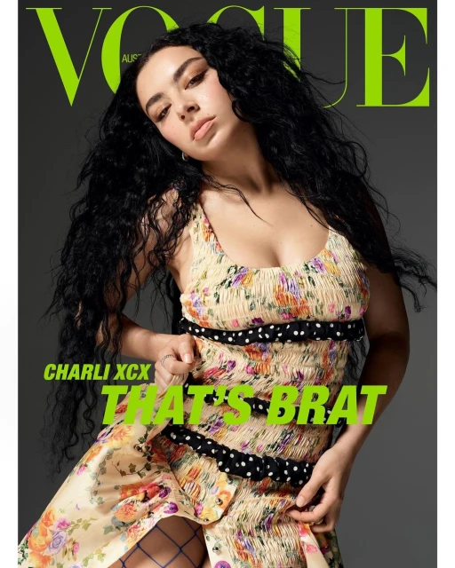 Vogue Australia cover featuring a young woman with long curly black hair, wearing a floral dress, in a studio shot with bright green text.