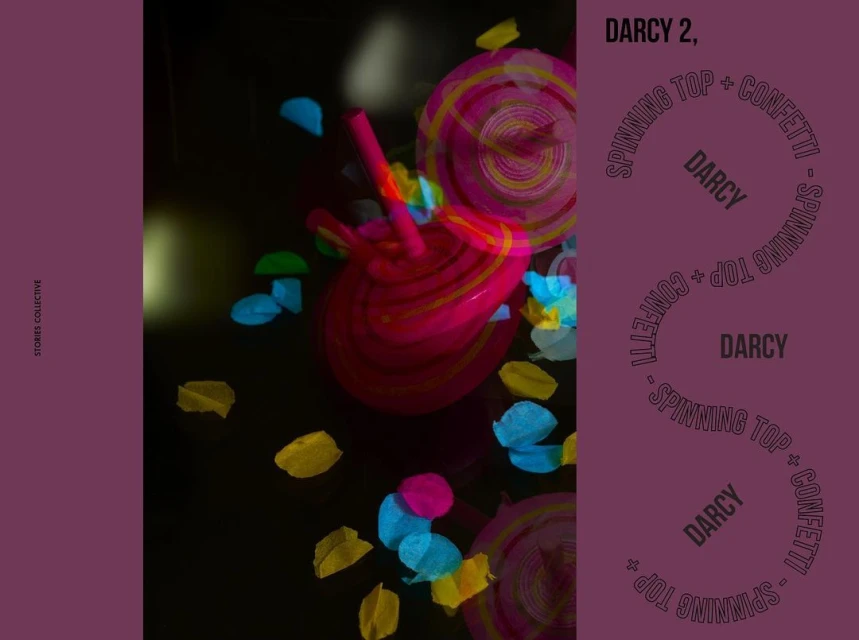 Abstract studio shot of spinning tops and confetti on a black background, featuring the words 'Darcy' and 'Stories Collective'.
