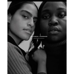 Close-up monochrome portrait of two women posing together, photographed by Amar Daved.