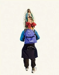 Person facing away wearing a blue backpack and holding a Virgin Mary statue with red roses on head against white background