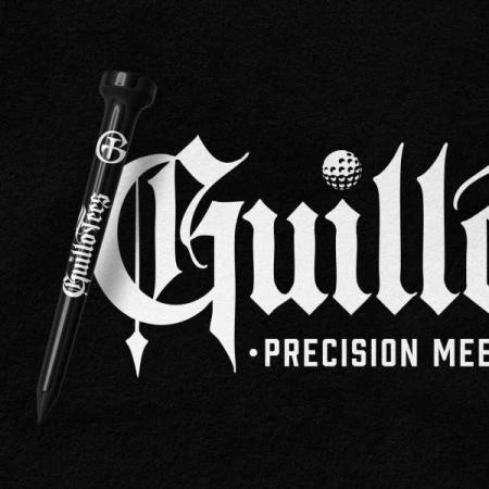 Close-up of a black golf tee alongside stylized white text that reads "Guillot Tees" on a dark textured background.