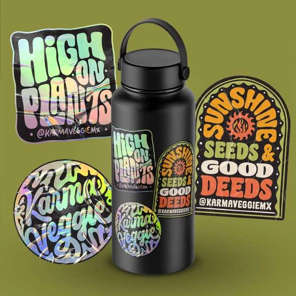 Black water bottle covered in holographic stickers with plant and sunshine themes against a soft green backdrop in a product shot.