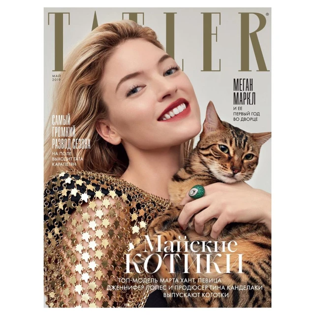 Magazine cover featuring a woman holding a cat, with the magazine title "Tatler" visible. Focus on fashion and beauty elements.