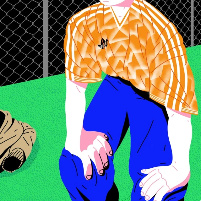 Illustration of a man in a soccer jersey and blue pants kneeling on a green field with a chain-link fence in the background.