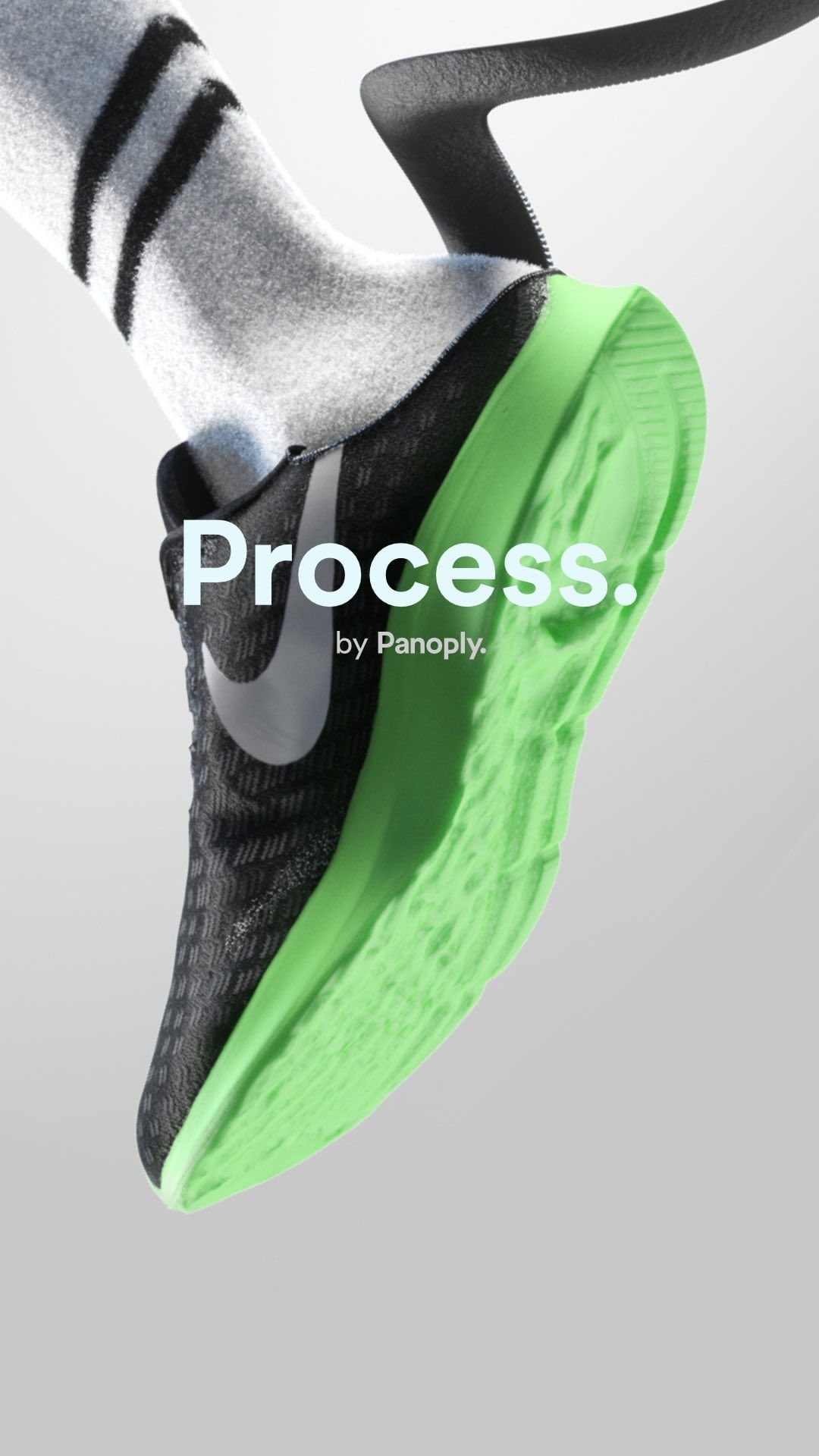 Close-up of a black and grey Nike sneaker with a bright green sole, paired with a striped sock, against a gradient grey background.