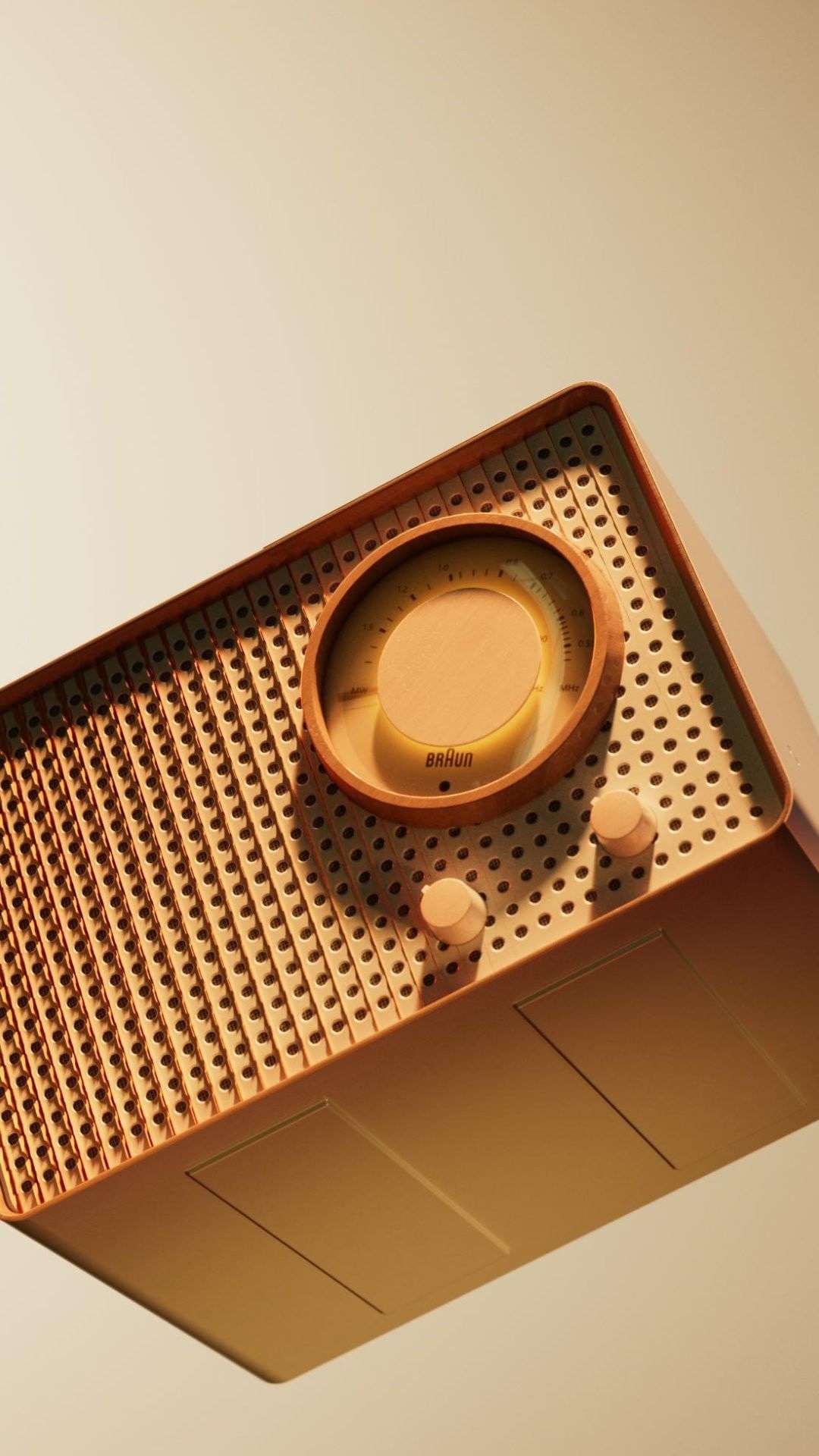 Angled view of a retro-style radio featuring a circular dial, speaker grill, and simple knobs against a light tan gradient background.