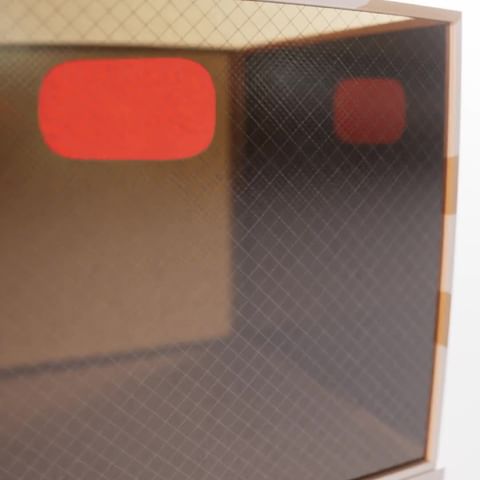 Abstract geometric interior view featuring glowing red rounded rectangles with a textured, grid-like pattern background and neutral walls.