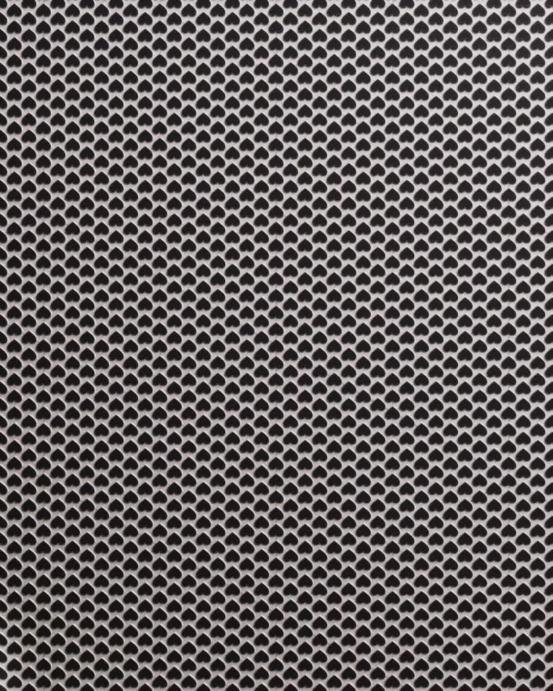 Pattern of black heart shapes on white background in a symmetrical grid design creating a visually appealing and modern texture.