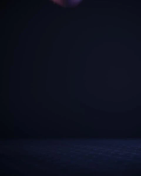 Dark, low-key image of a room with a blue-gray floor, shot in a photo studio. The background is a gradient of dark blue to black.