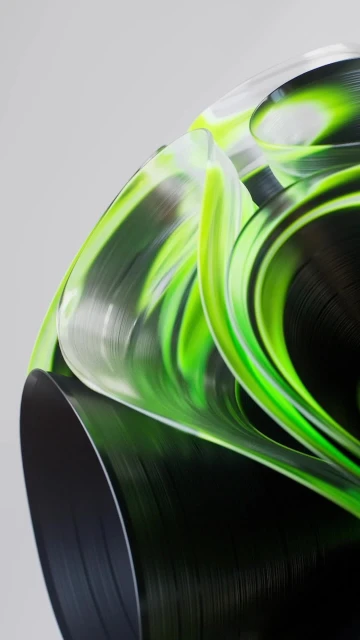 Abstract image of a sculptural green and black swirling design with smooth textures against a light gray background, close-up shot.