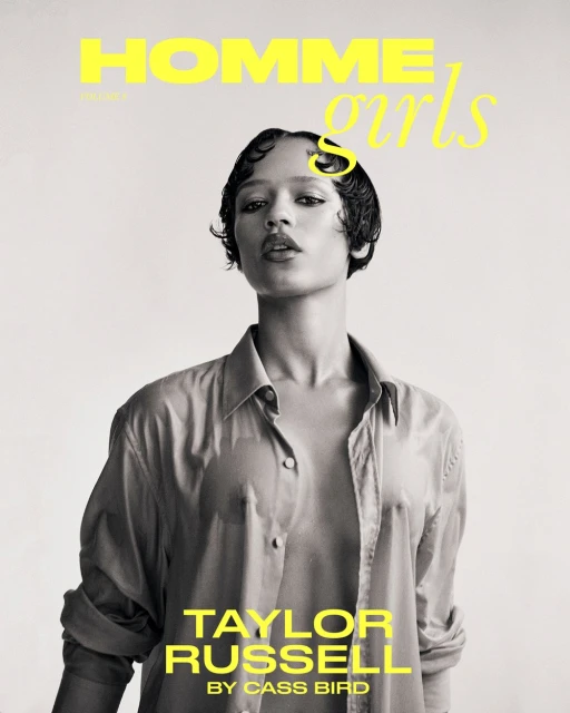 Black and white portrait of Taylor Russell on the cover of Homme Girls magazine, wearing a sheer button-down shirt and glossy short hair.