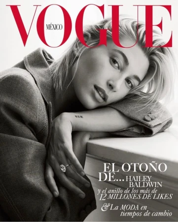 Vogue Mexico cover featuring Hailey Baldwin with a ring. Close-up shot in neutral tones and red typography, capturing a stylish editorial moment.