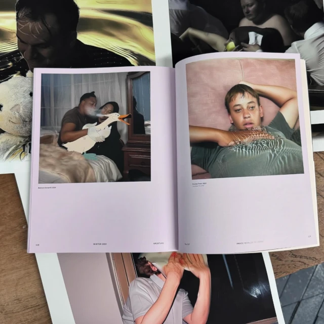 Open book displaying two photographs: one featuring a couple with a duck puppet, and the other a person lying on a pink surface.
