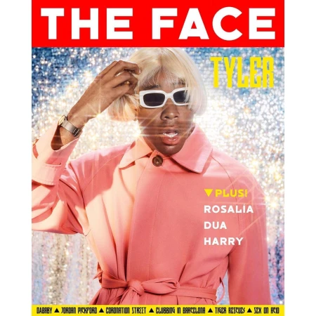 Magazine cover featuring a person with fair skin, wearing sunglasses and a two-tone pink coat, posing in front of a sparkling backdrop.