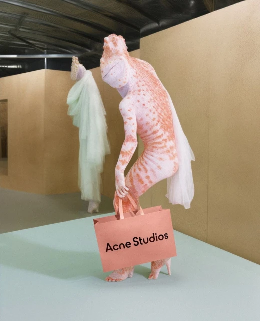 Two mannequin figures, one salmon-colored with spots carrying a shopping bag with the logo Acne Studios and one wearing a white dress.