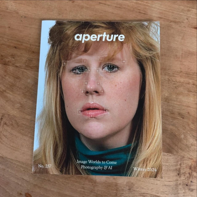Magazine cover featuring a close-up portrait of a woman with blonde hair, wearing a teal top. Text reads 'aperture, Image Worlds to Come'.