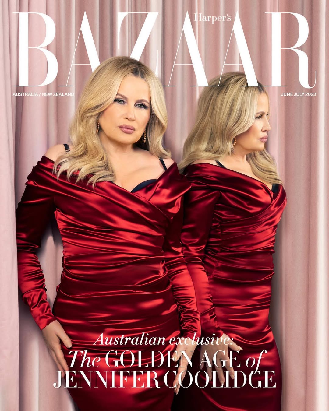 Jennifer Coolidge stars on Harper's Bazaar Australia cover. The actress wears a red satin off-the-shoulder dress against a pink backdrop.