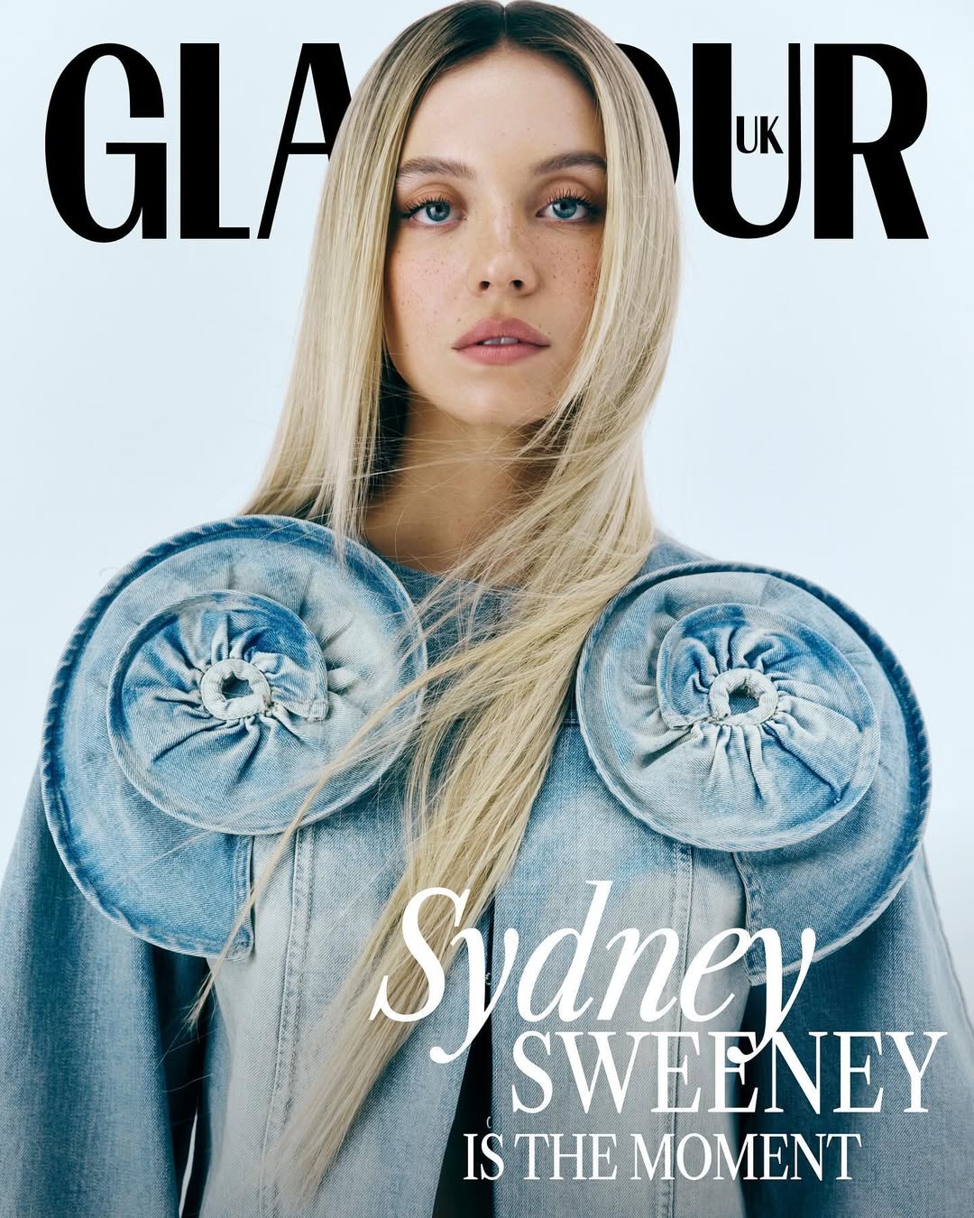 Glamour UK magazine cover featuring Sydney Sweeney in a light blue denim jacket with oversized shoulder embellishments.