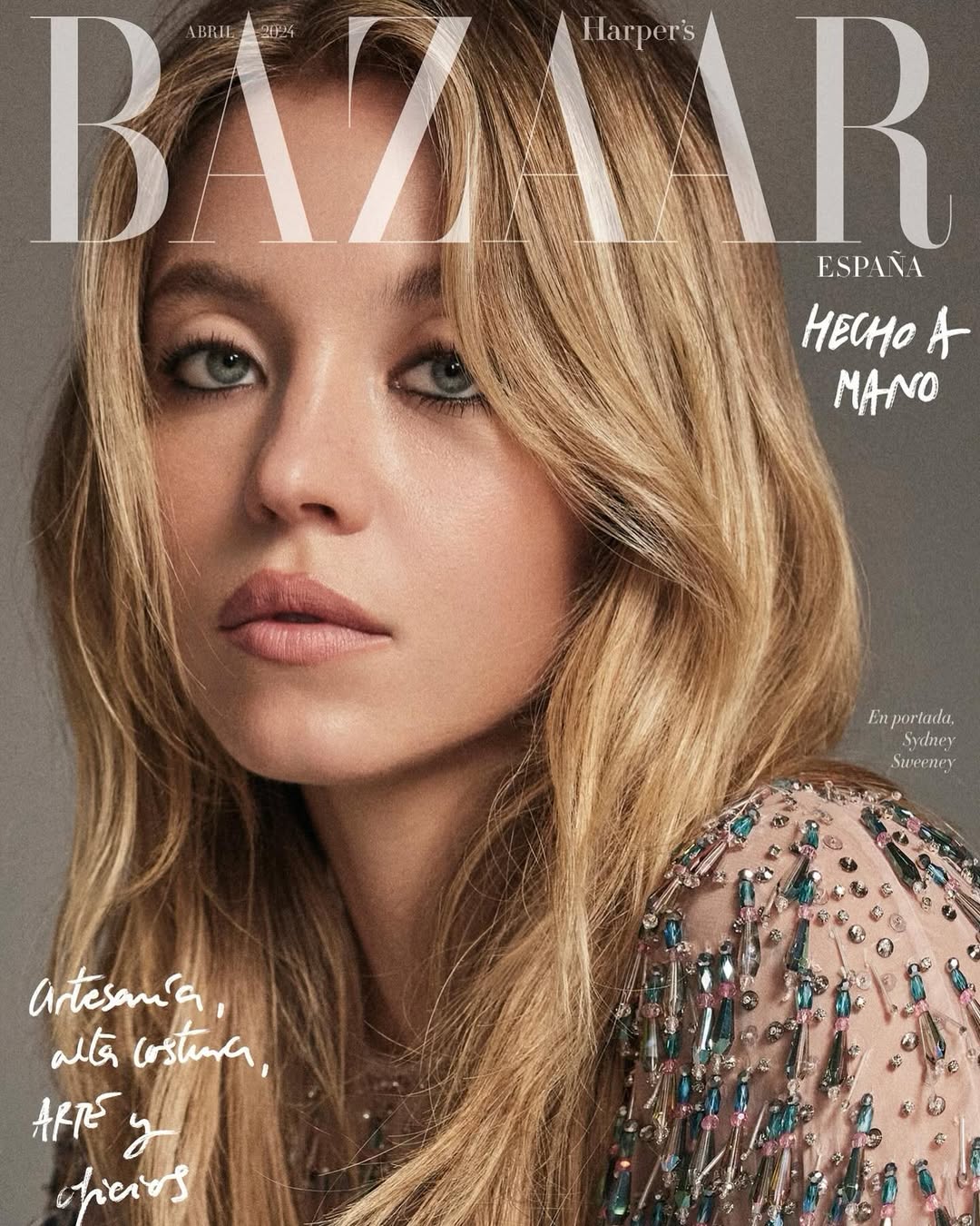 Close-up of Sydney Sweeney on Harper's Bazaar España cover, wearing embellished dress with blonde wavy hair and neutral makeup.