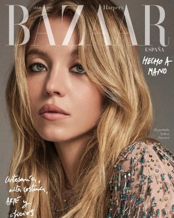 Sydney Sweeney on Harper's Bazaar España cover. Close-up of a blonde woman with light makeup in a beaded dress against a grey backdrop.
