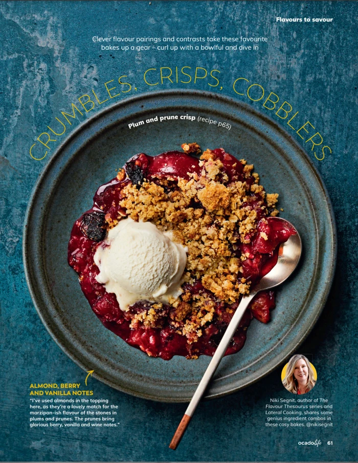 Plum and prune crisp with ice cream in a grey bowl on a textured teal surface