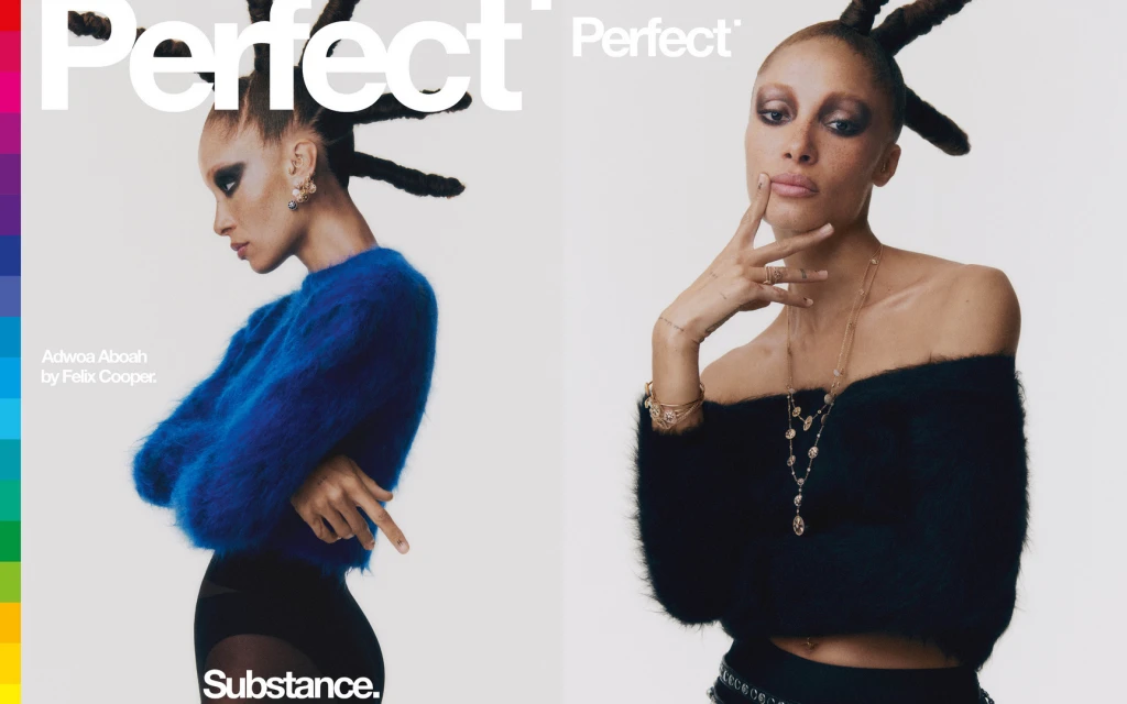 Two women pose indoors for a fashion cover; one wears a blue sweater with black tights, while the other wears a black sweater with jewelry.