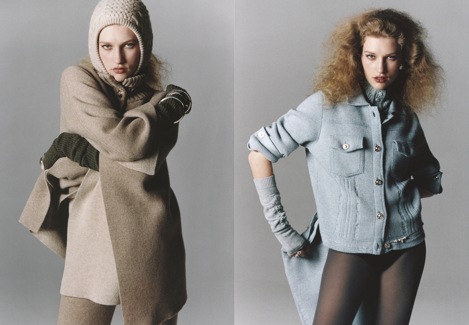 Two fashion models pose in front of a gray studio background, each wearing knit hats, gloves, and outerwear in a minimalist fashion shoot.