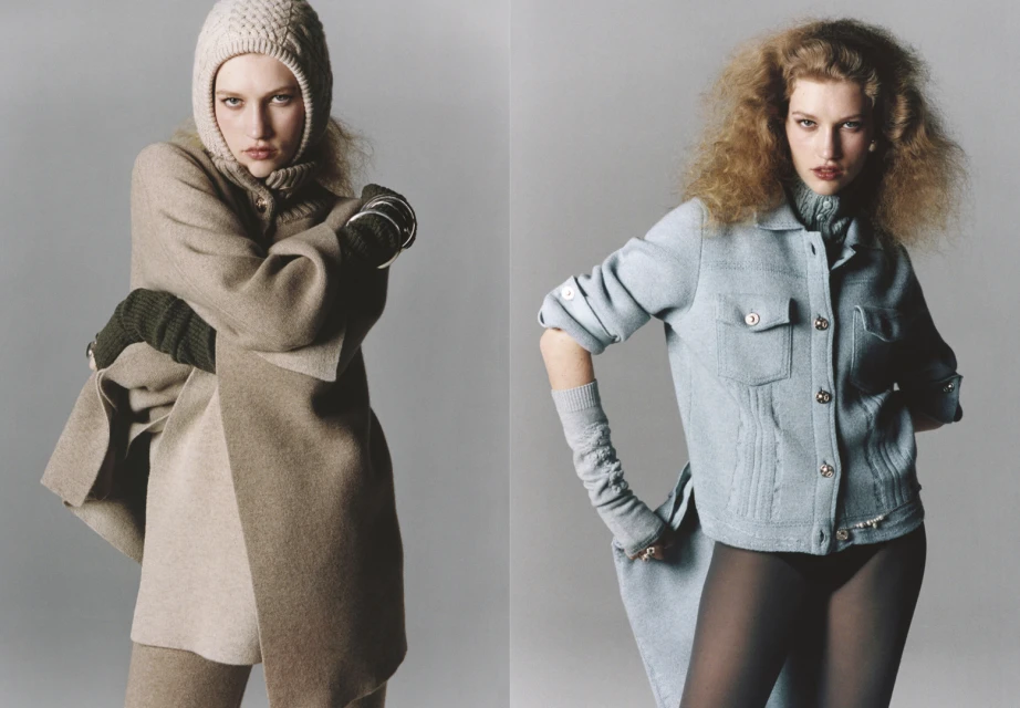 Two fashion models pose in front of a gray studio background, each wearing knit hats, gloves, and outerwear in a minimalist fashion shoot.