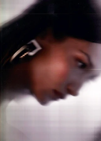 Close-up portrait of a woman wearing statement geometric earrings by photographer Joe Cruz