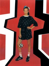 Young woman standing in black patterned outfit holding a checkerboard sphere bag against a red and black abstract backdrop