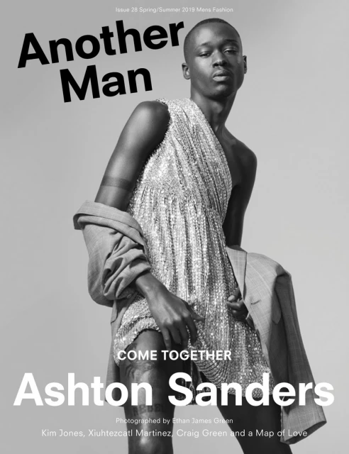Black and white fashion magazine cover featuring a Black male model wearing a sparkly dress and suit jacket. 'Another Man' magazine.