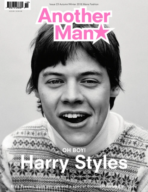 Black-and-white magazine cover featuring a close-up of Harry Styles with a wide, open-mouthed smile and a patterned sweater.