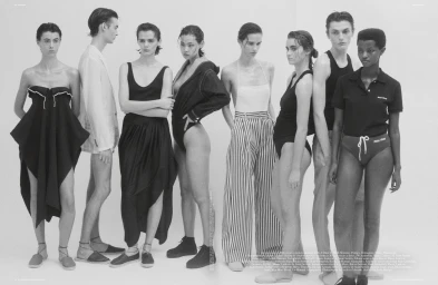 Group of eight models in diverse black and white fashion apparel posing against a plain white background styled by Jodie Barnes