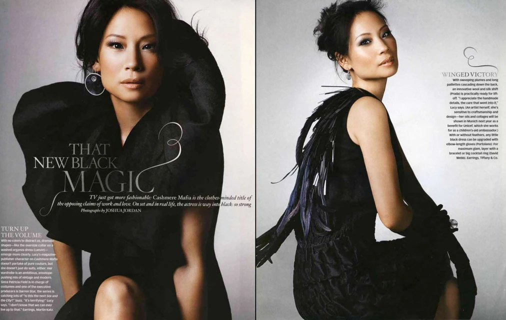 Lucy Liu poses in two-page spread. On the left she wears a black dress with large sleeves, and on the right is a black dress with feathers.