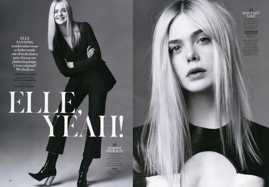 Elle Fanning poses in a black suit and shiny heeled boots on a magazine cover spread with bold text and a close-up portrait.