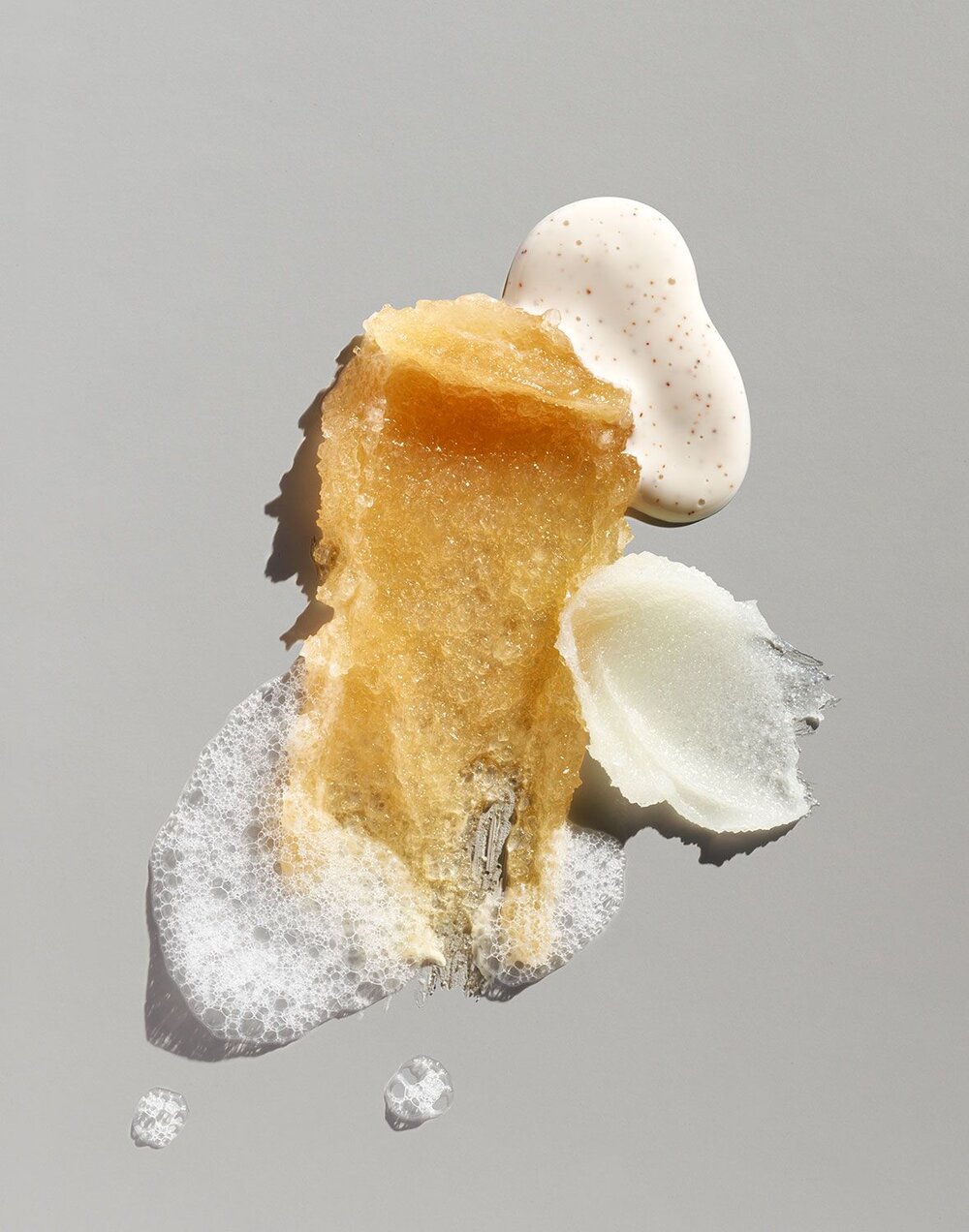 Cosmetic product smears in neutral hues. A collection of different textures and consistencies. Beauty product photography.