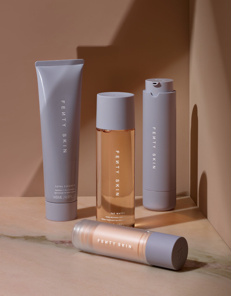 Four Fenty Skin skincare products including cleanser, toner, and moisturizer displayed on a marble surface with a neutral background.