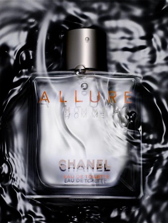Close-up studio shot of a clear Chanel Allure Homme Eau de Toilette bottle with a silver cap, surrounded by water, and sleek dark background.